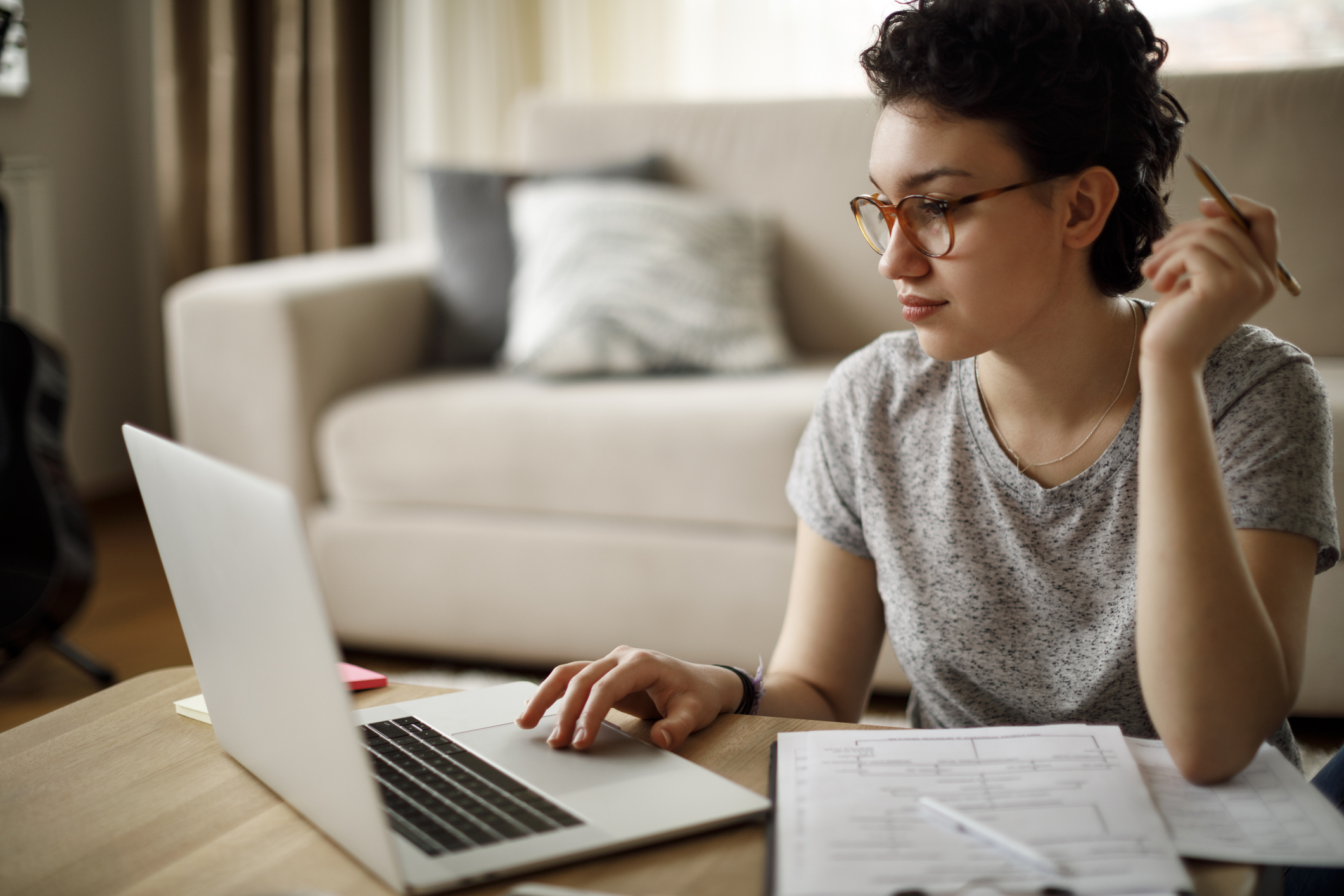 Junge Frau mit Brille vor Laptop wendet Lernstrategie mit Mindmap an